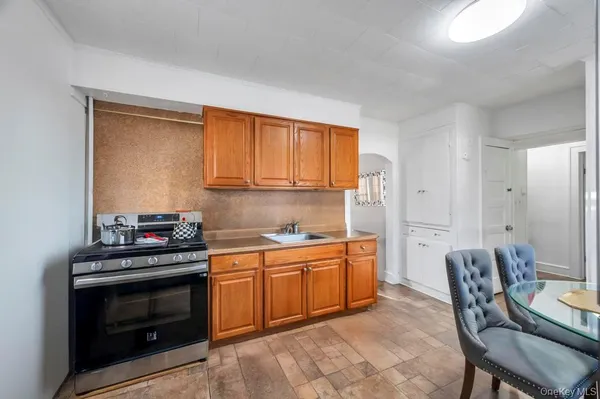 a kitchen with stainless steel appliances a stove a sink and a refrigerator