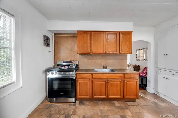 a kitchen with a stove top oven cabinets and a refrigerator