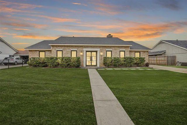 a living room with furniture a flat screen tv and a window