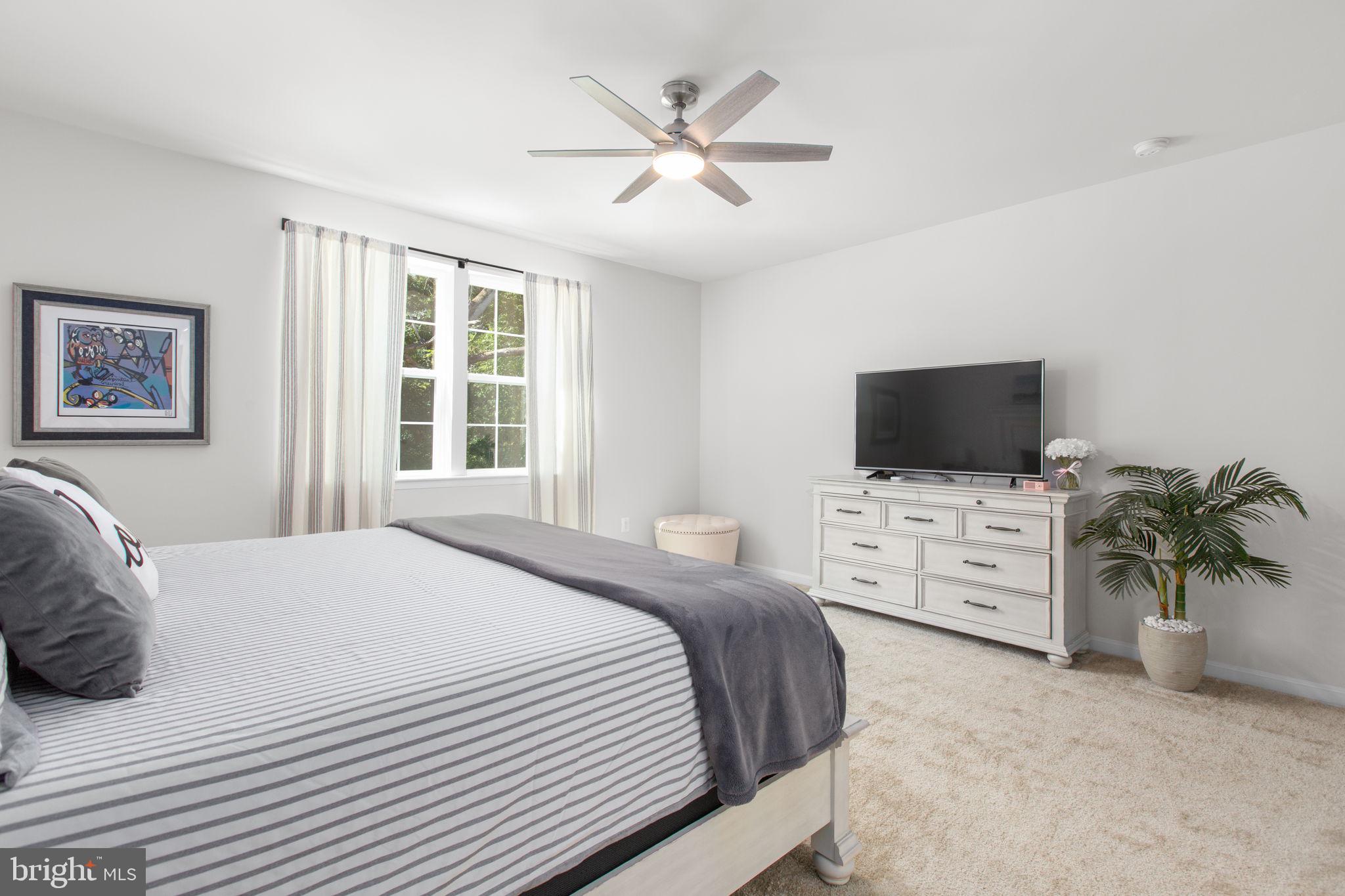 6306 Bobcat Lane King George, VA 22485 - Photo 19 of 58 a bedroom with a bed flat screen tv and a window