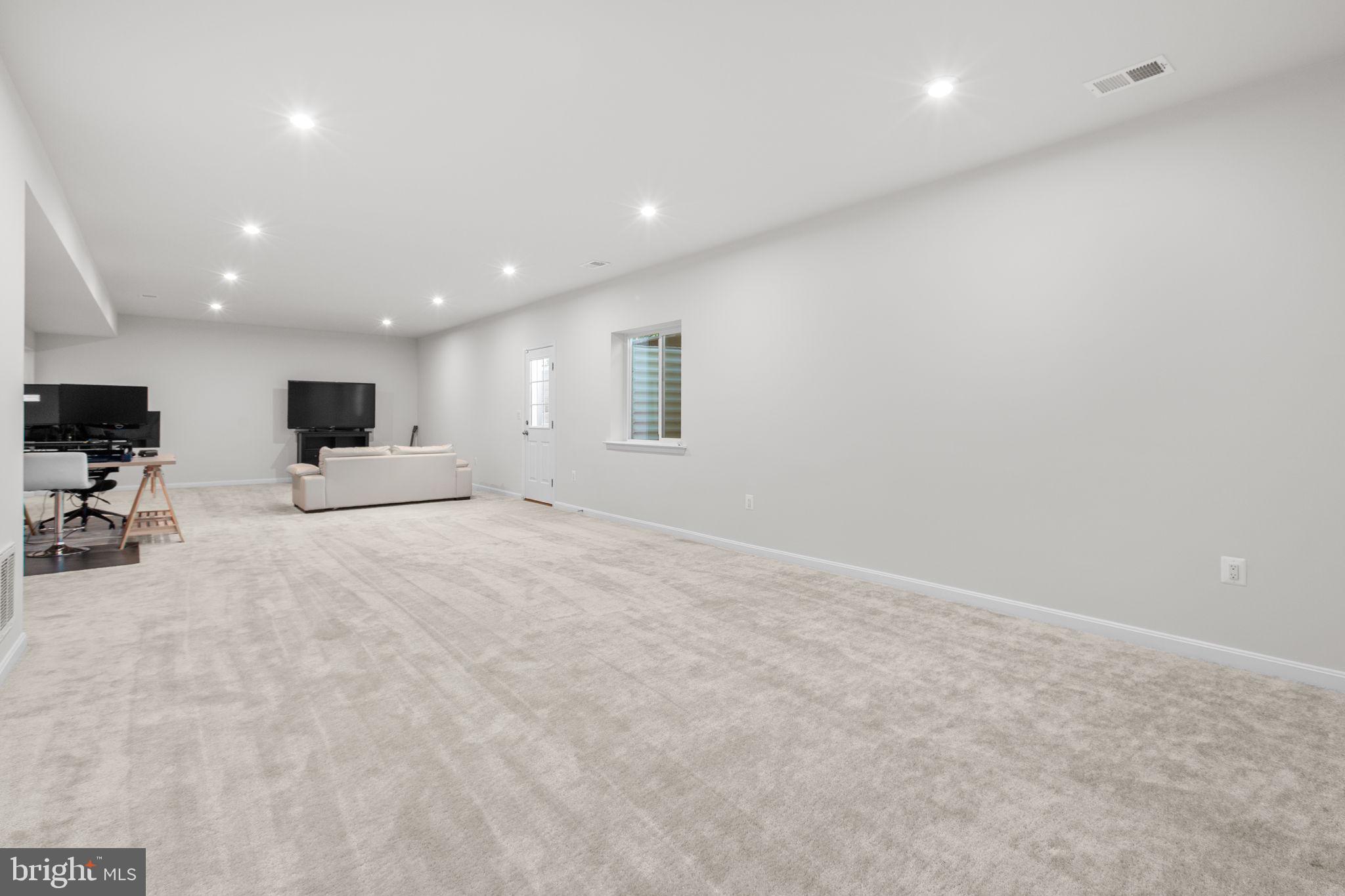 6306 Bobcat Lane King George, VA 22485 - Photo 34 of 58 an empty room with furniture and a flat screen tv