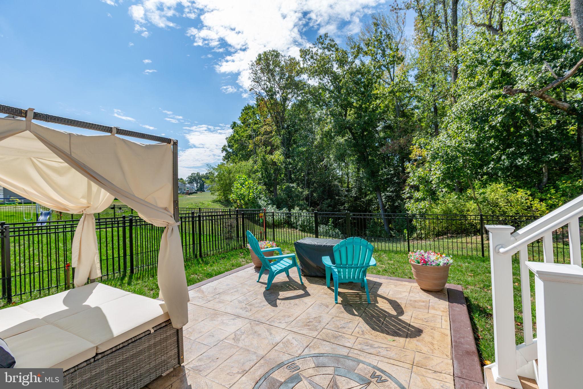 6306 Bobcat Lane King George, VA 22485 - Photo 38 of 58 a view of a backyard with couches chair and wooden fence