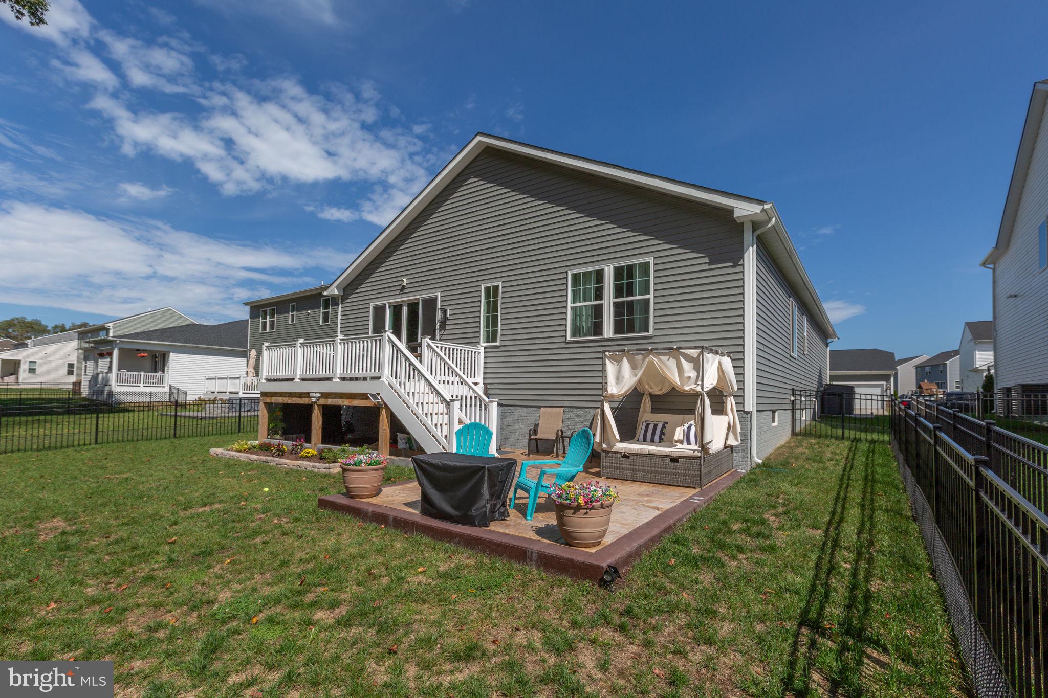 6306 Bobcat Lane King George, VA 22485 - Photo 43 of 58 a front view of a house with a yard table and chairs
