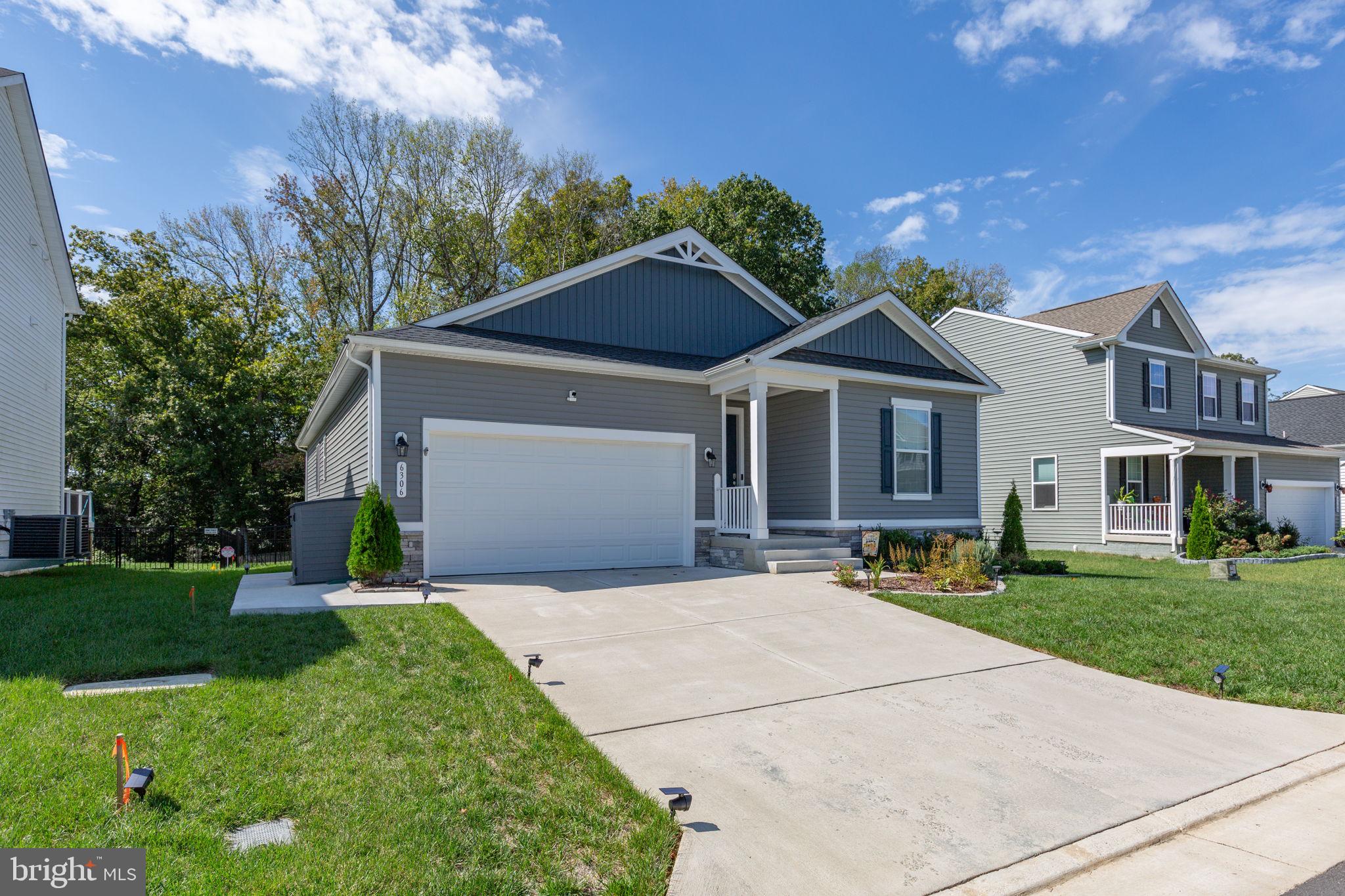 6306 Bobcat Lane King George, VA 22485 - Photo 55 of 58 a front view of a house with a garden and trees