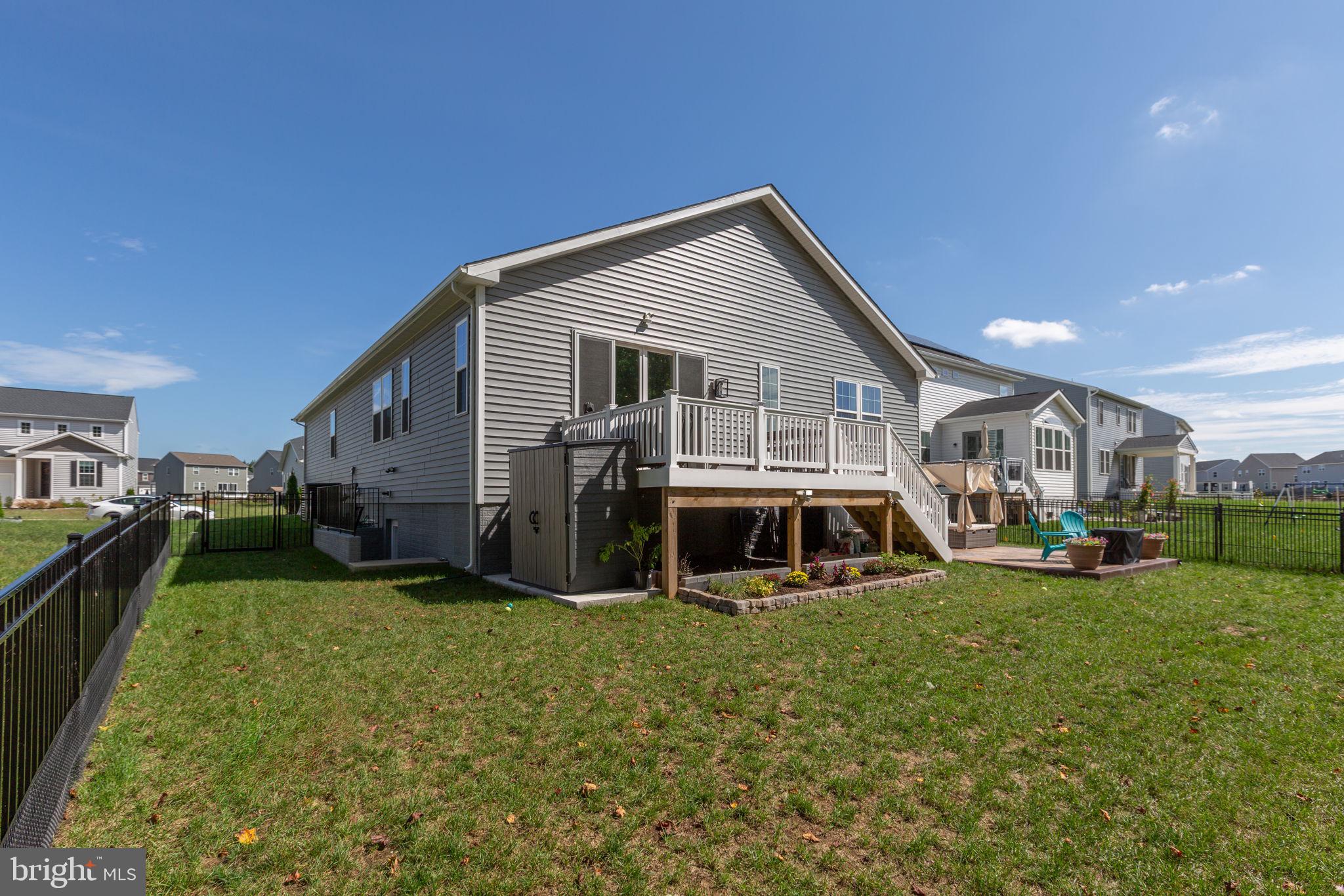 6306 Bobcat Lane King George, VA 22485 - Photo 56 of 58 a view of a house with a yard and sitting area