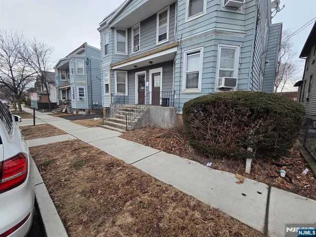 a view of a wooden bench and a clock on a wall