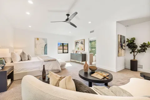 a bedroom with a large bed and a chandelier