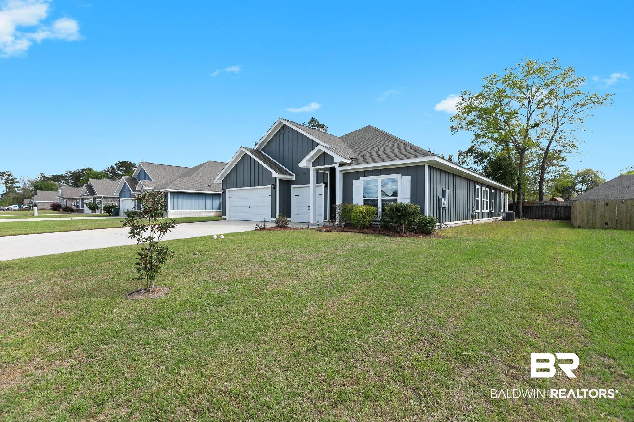 9448 Amethyst Drive Daphne, AL 36526 - Photo 4 of 61 View of front of home featuring board and batten siding, driveway, an attached garage, and a shingled roof