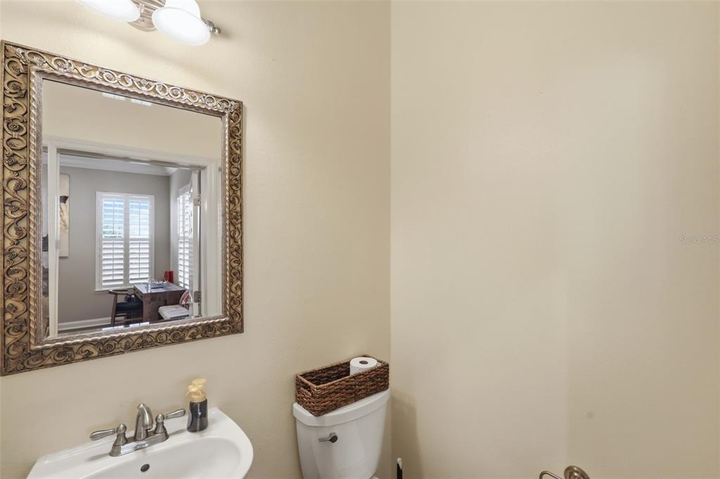 907 Pawstand Road Celebration, FL 34747 - Photo 34 of 49 a bathroom with a toilet sink and mirror