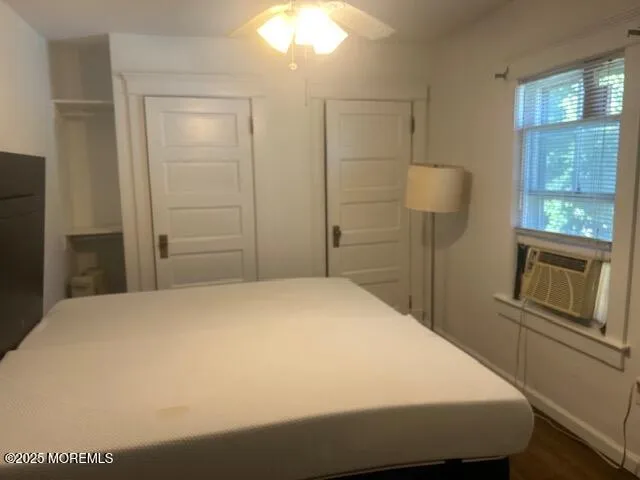 a bedroom with a bed and cabinet