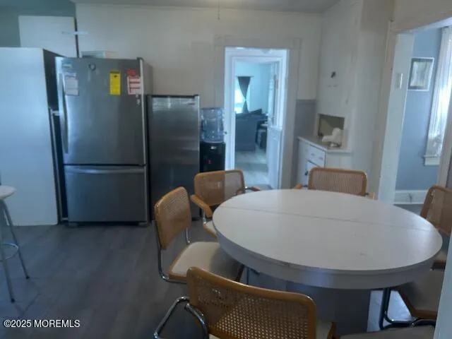 a kitchen with stainless steel appliances a refrigerator and a table