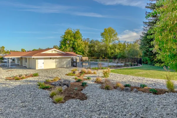 a view of a house with a backyard