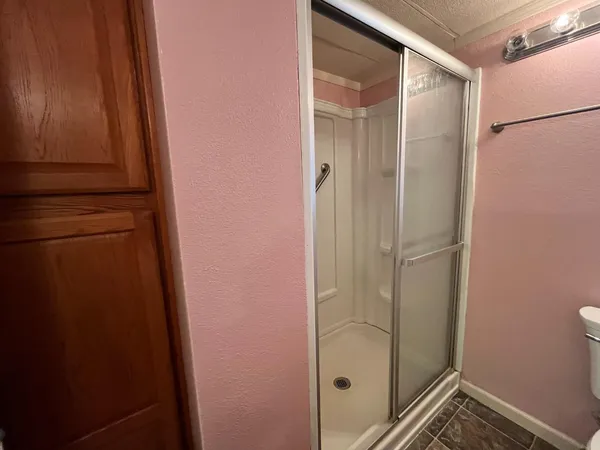 a bathroom with a glass shower door