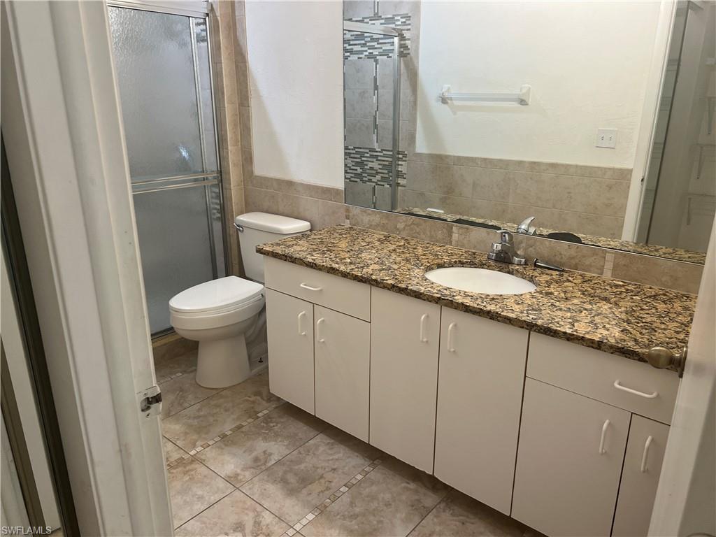 3841 Schoolhouse Road East, Unit 7 Fort Myers, FL 33916 - Photo 12 of 24 a bathroom with a granite countertop sink and a mirror