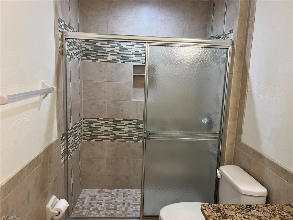 3841 Schoolhouse Road East, Unit 7 Fort Myers, FL 33916 - Photo 21 of 24 a bathroom with a shower a toilet and a sink