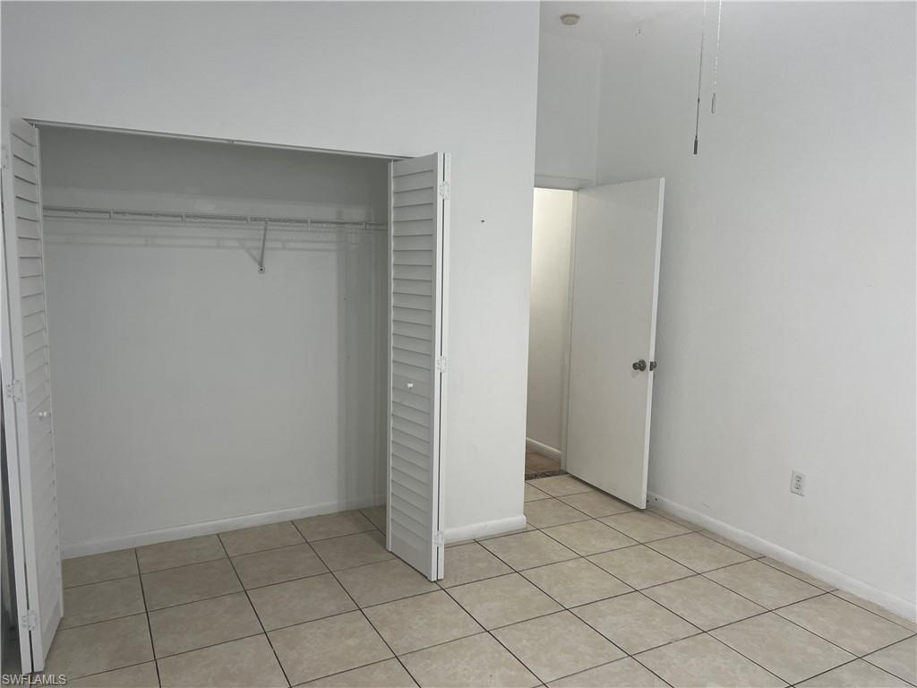 3841 Schoolhouse Road East, Unit 7 Fort Myers, FL 33916 - Photo 3 of 24 an empty room with white door