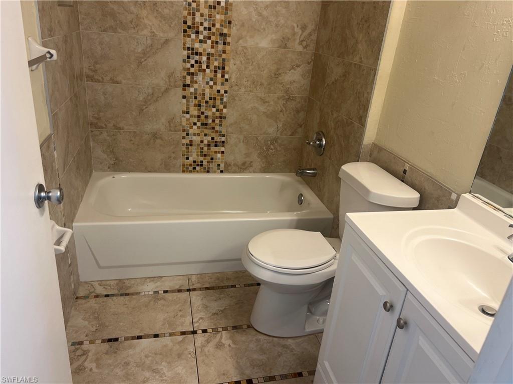 3841 Schoolhouse Road East, Unit 7 Fort Myers, FL 33916 - Photo 4 of 24 a bathroom with a sink a toilet and bathtub