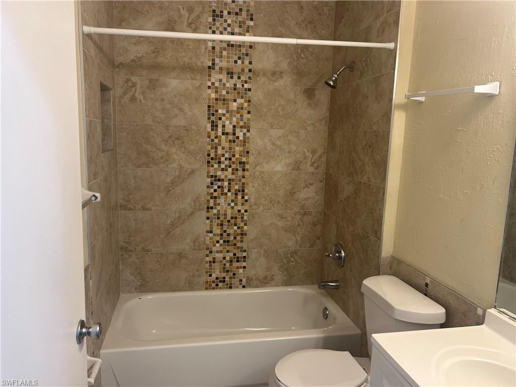 3841 Schoolhouse Road East, Unit 7 Fort Myers, FL 33916 - Photo 5 of 24 a bathroom with a bathtub and shower