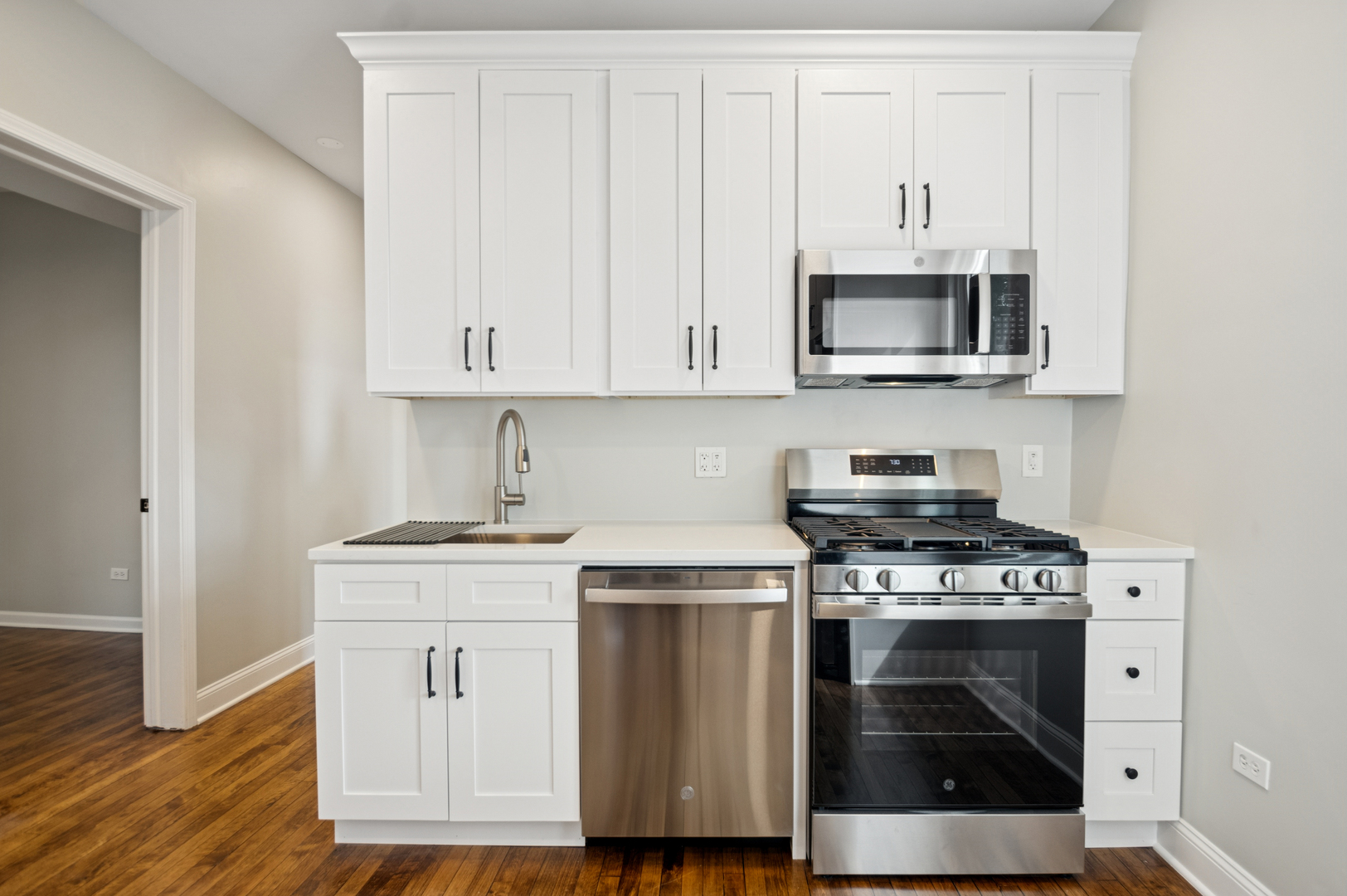 3300 North Karlov Avenue, Unit 1 Chicago, IL 60641 - Photo 11 of 17 a kitchen with stainless steel appliances granite countertop a stove a microwave and cabinets