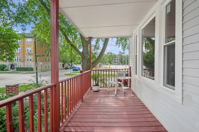 a view of a balcony with wooden floor
