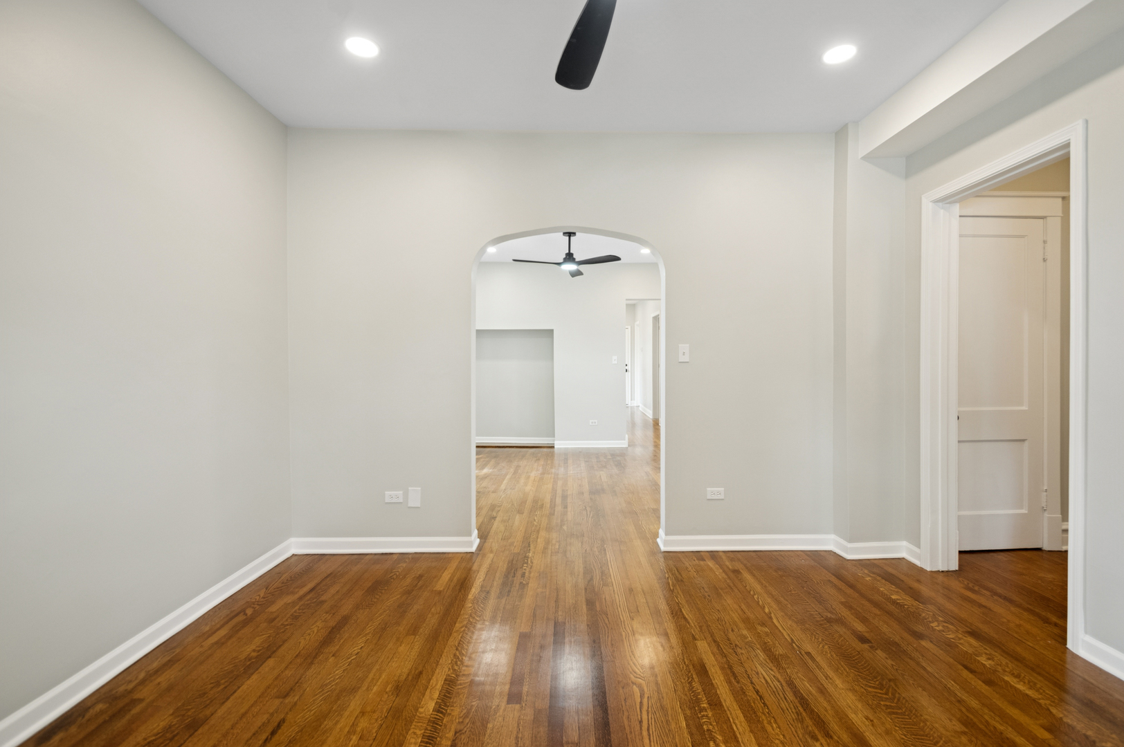 3300 North Karlov Avenue, Unit 1 Chicago, IL 60641 - Photo 4 of 17 a view of empty room with wooden floor and fan