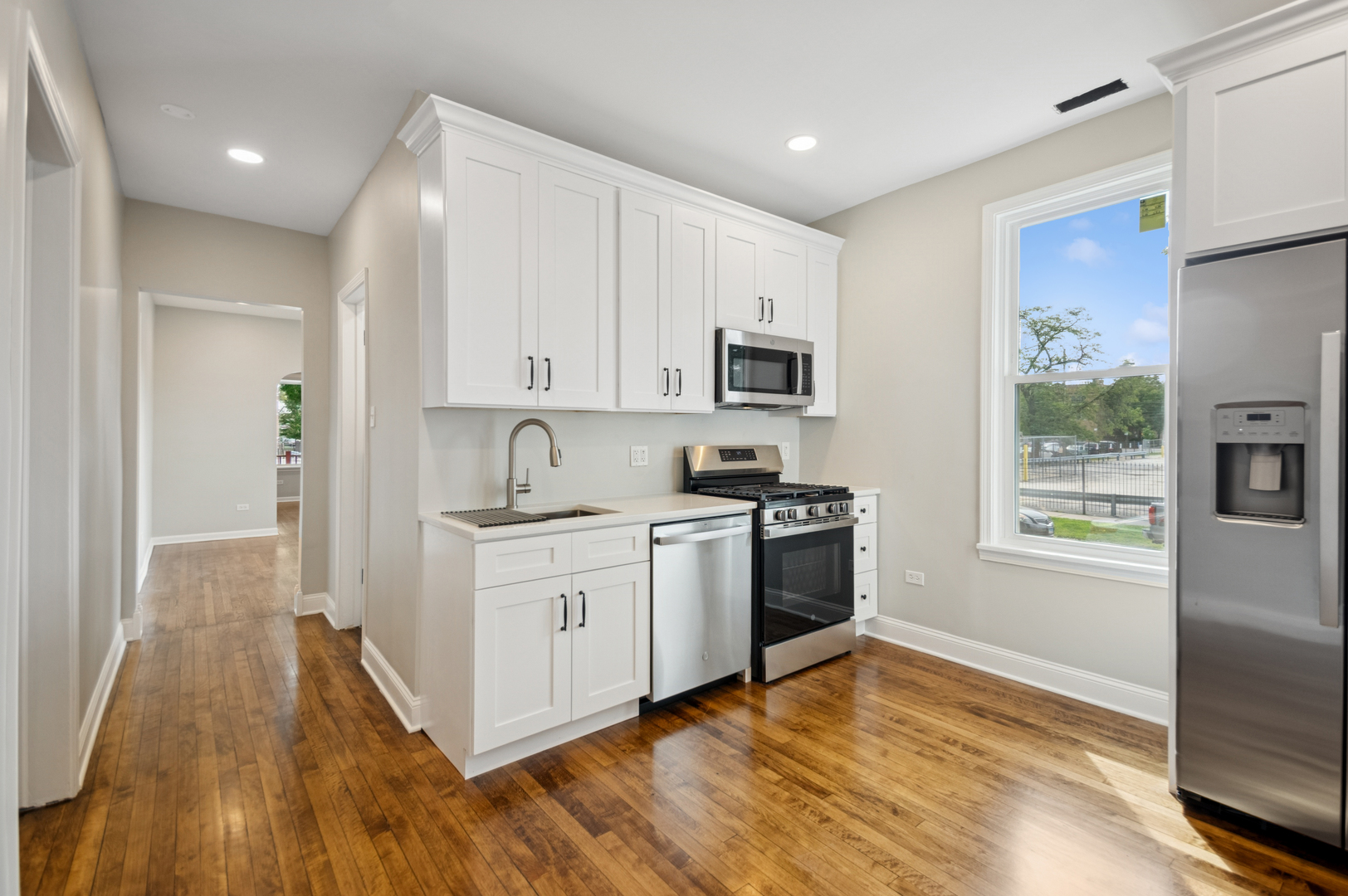 3300 North Karlov Avenue, Unit 1 Chicago, IL 60641 - Photo 8 of 17 a kitchen with stainless steel appliances granite countertop a stove a sink and a refrigerator