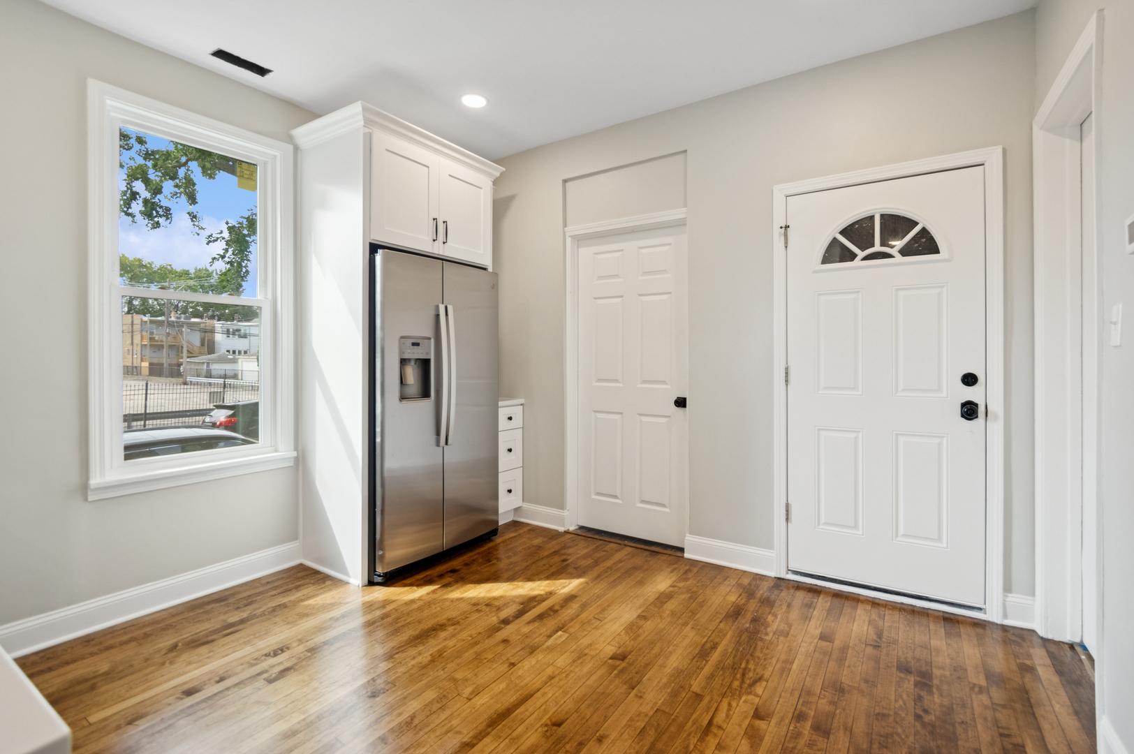 3300 North Karlov Avenue, Unit 1 Chicago, IL 60641 - Photo 9 of 17 a view of an empty room with wooden floor and a window