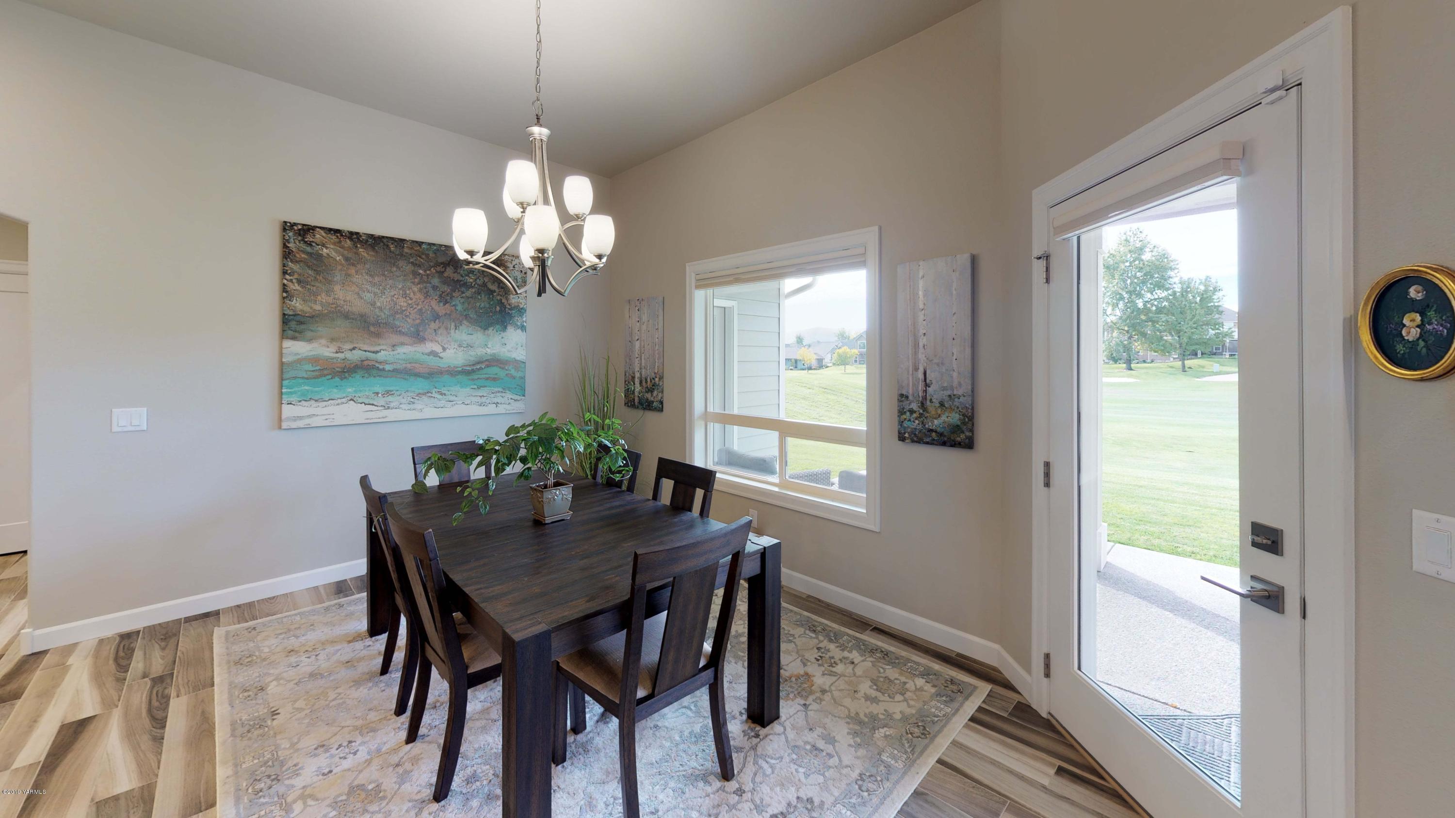 9104 Coolidge Road Yakima, WA 98903 - Photo 9 of 21 a dining room with furniture a window and a chandelier
