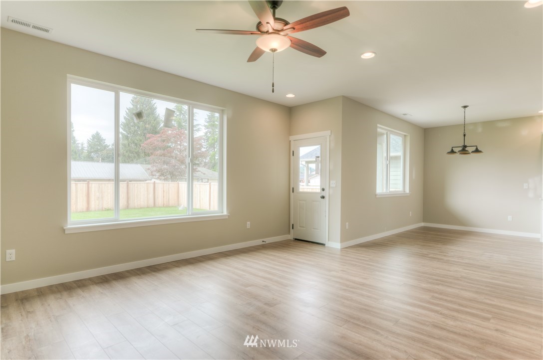 3294 Prill Road Centralia, WA 98531 - Photo 3 of 23 a view of an empty room with a window and wooden floor