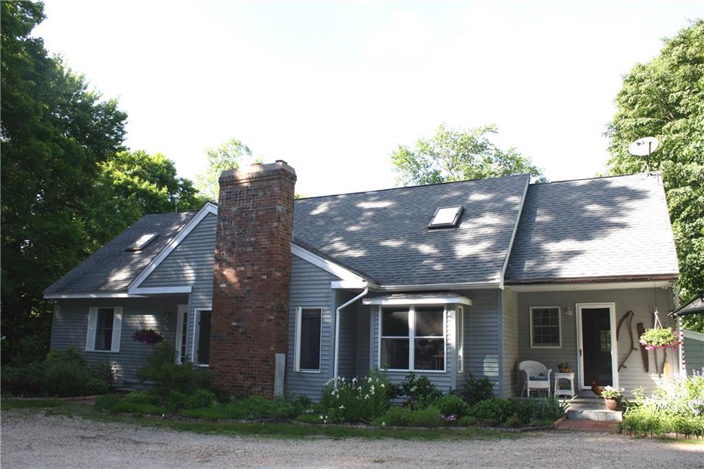 82 West Side Road Goshen, CT 06756 - Photo 1 of 1 a view of a brick house next to a yard with potted plants