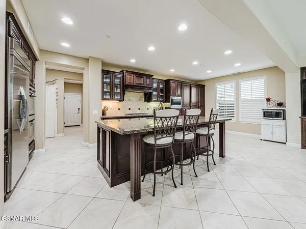 a living room with furniture and kitchen view