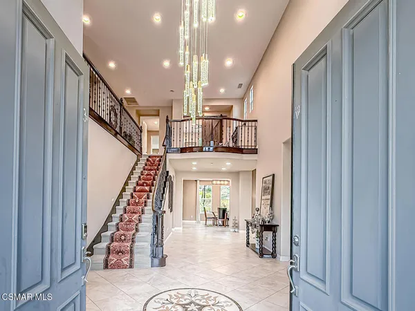 a living room with fireplace furniture and a rug