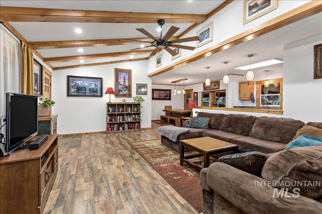 79 Sunset Loop Cascade, ID 83611 - Photo 9 of 44 Open-concept living area featuring wood-finish flooring, vaulted ceilings with exposed wood beams, and recessed lighting