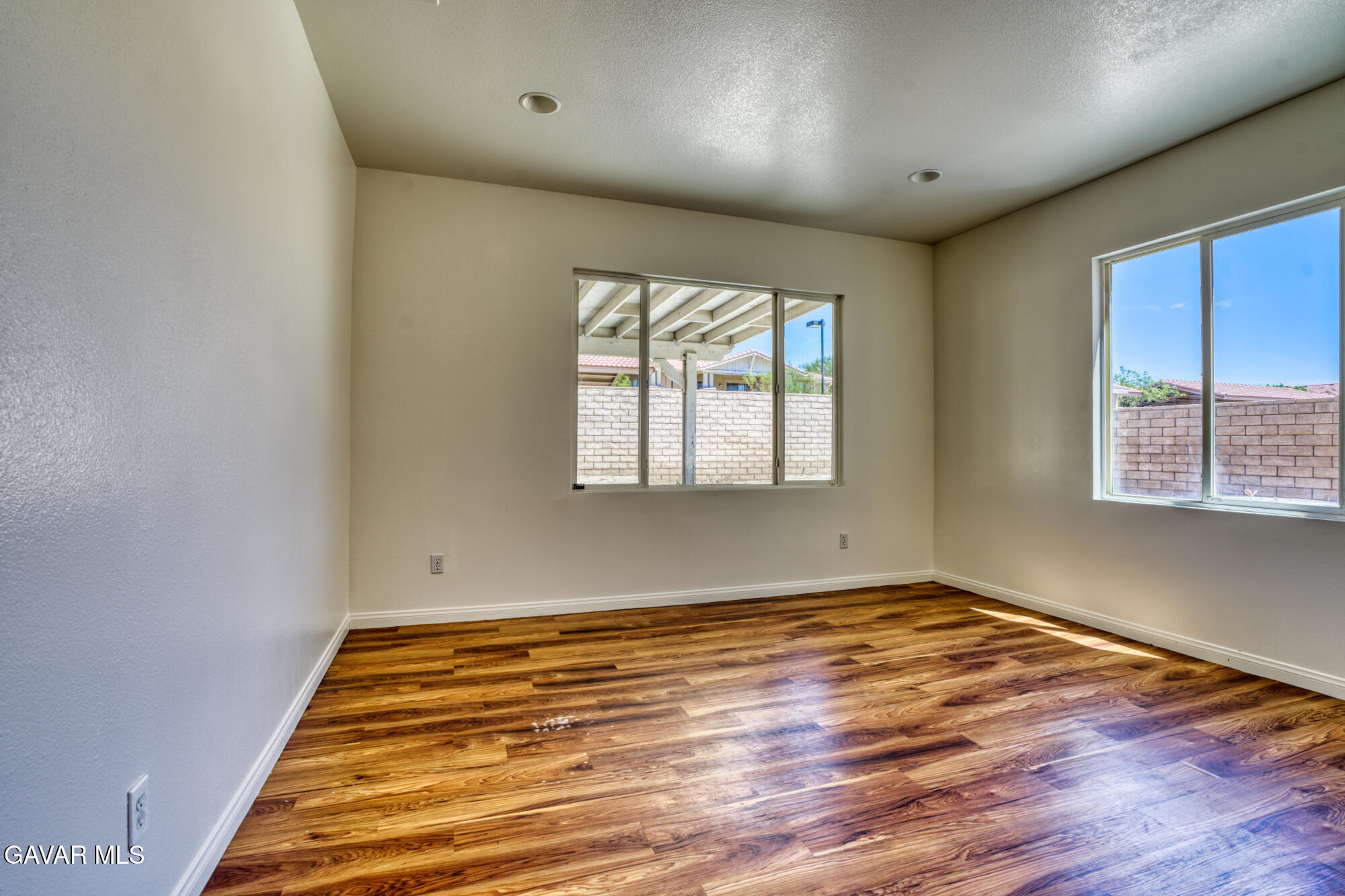 37928 Pisces Circle Palmdale, CA 93552 - Photo 23 of 32 an empty room with wooden floor and windows
