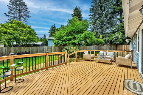 a view of a roof deck with wooden floor and seating space