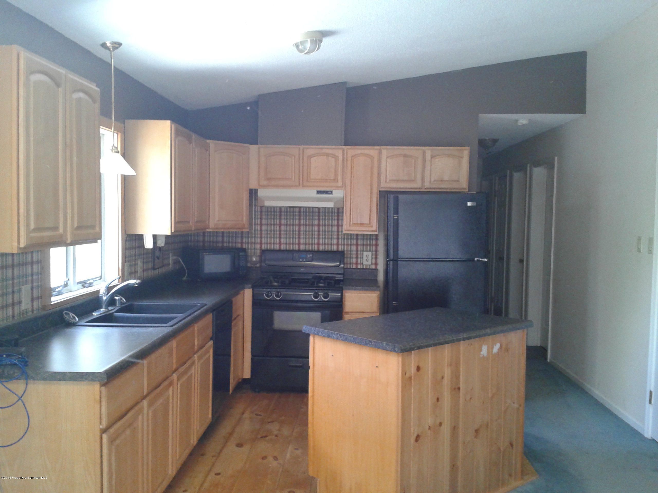 88 Lake Side Road Hop Bottom, PA 18824 - Photo 18 of 40 a kitchen with stainless steel appliances granite countertop a sink stove and refrigerator