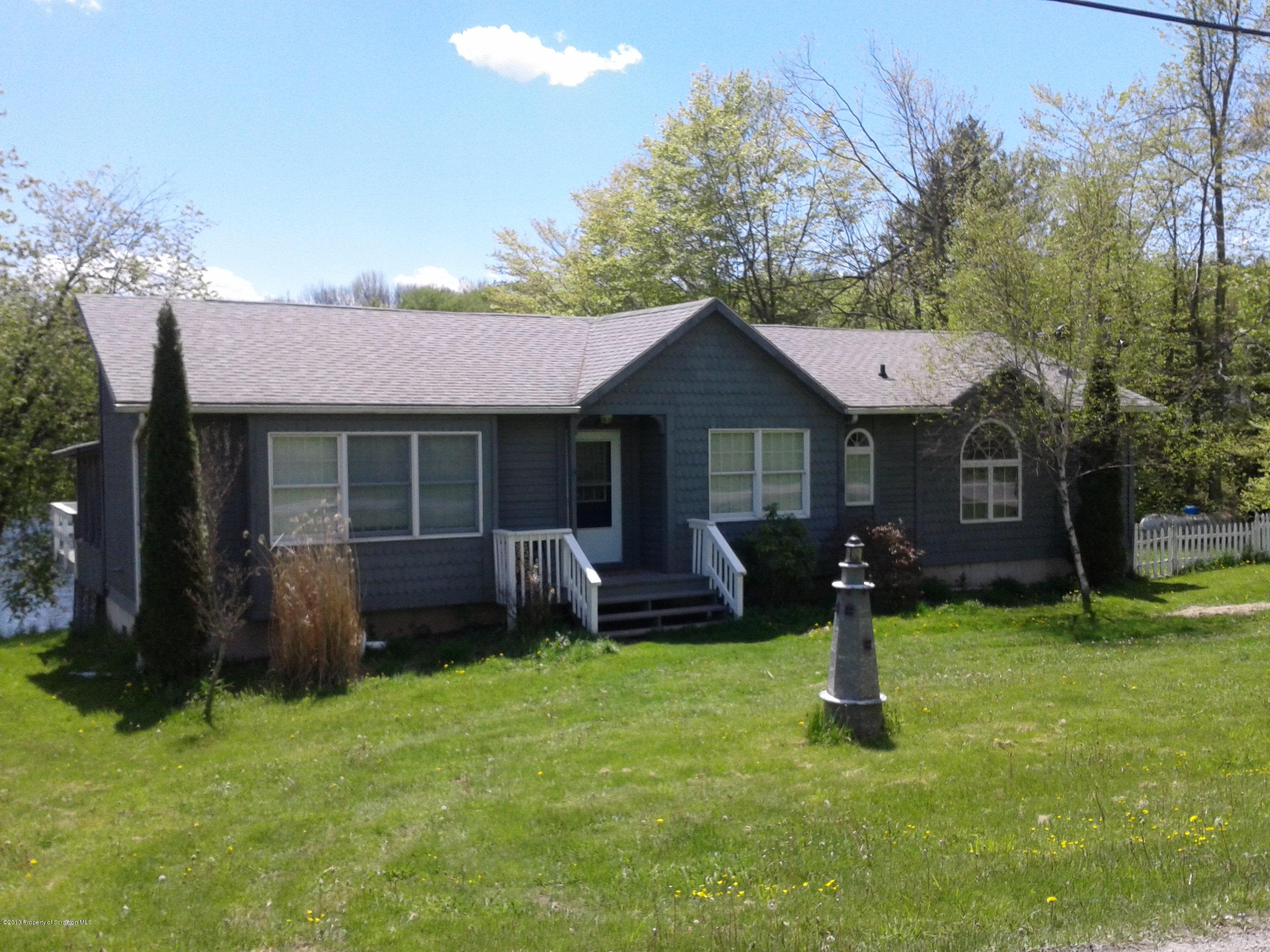 88 Lake Side Road Hop Bottom, PA 18824 - Photo 3 of 40 a front view of a house with a yard and tree