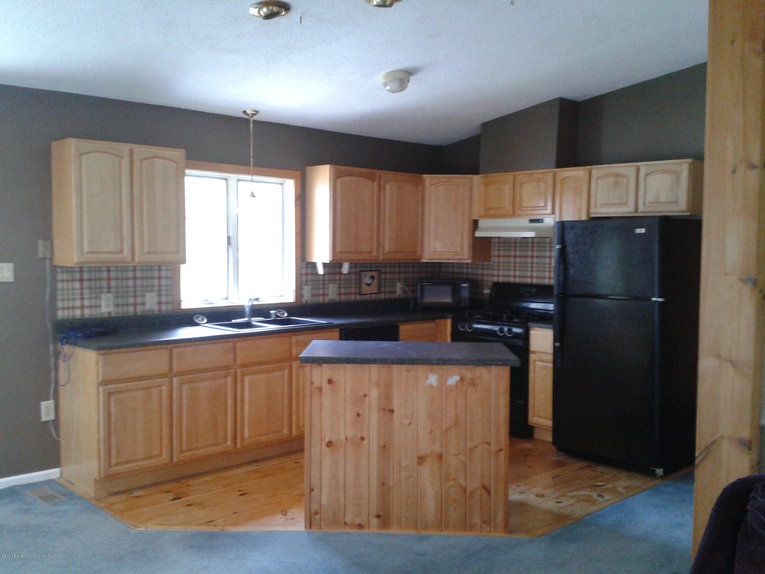 88 Lake Side Road Hop Bottom, PA 18824 - Photo 37 of 40 a kitchen with stainless steel appliances a refrigerator a sink a stove a counter space and cabinets
