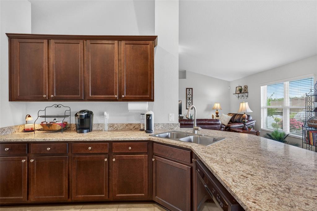 2429 Twin Lake View Road Winter Haven, FL 33881 - Photo 16 of 37 a kitchen with granite countertop a sink a stove and cabinets