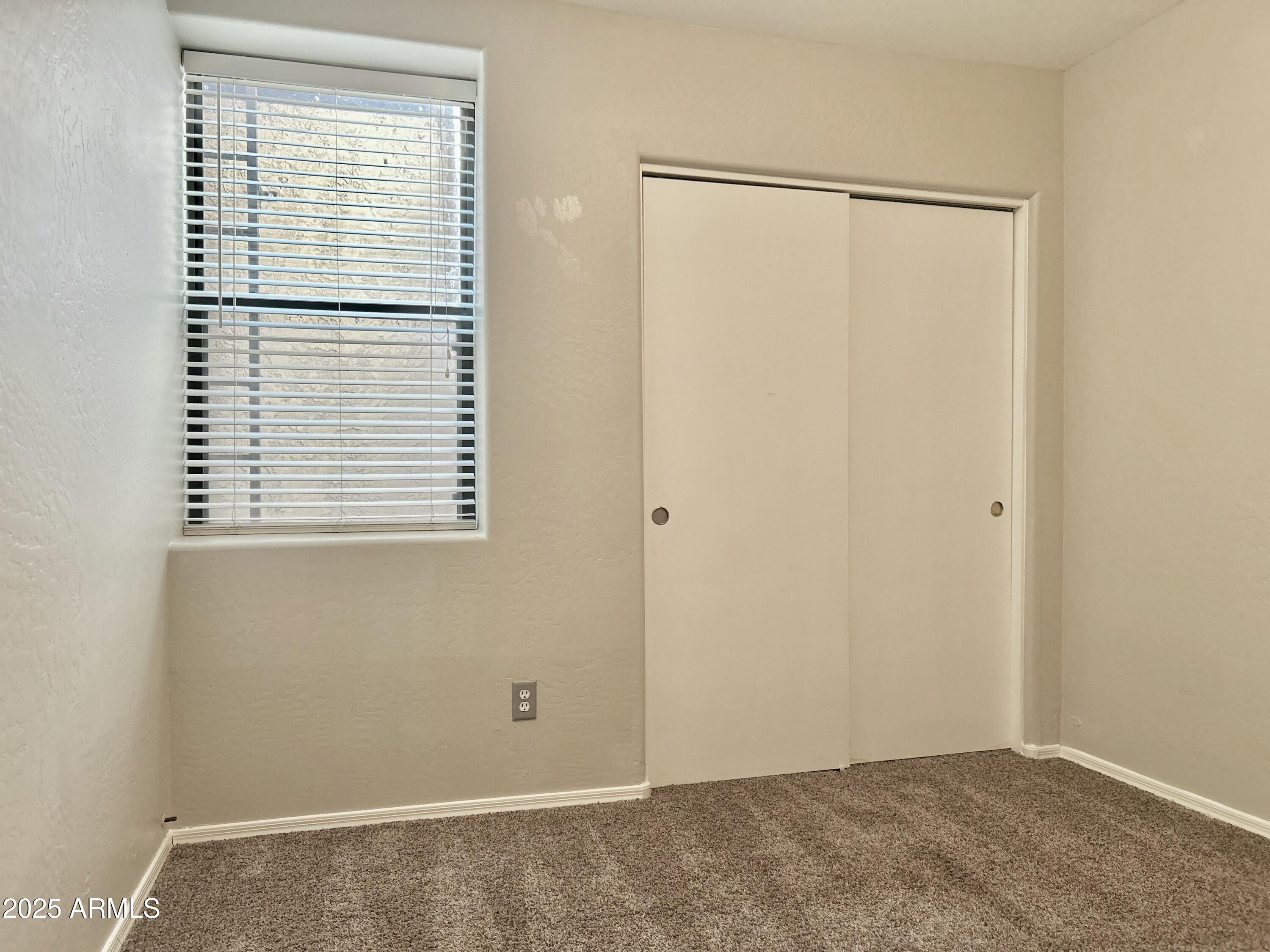 4423 East McLellan Road, Unit 115 Mesa, AZ 85205 - Photo 11 of 16 a view of an empty room with a window