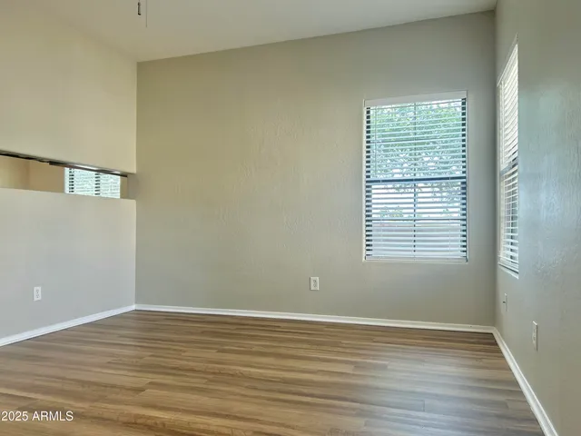 a view of a room with wooden floor and windows
