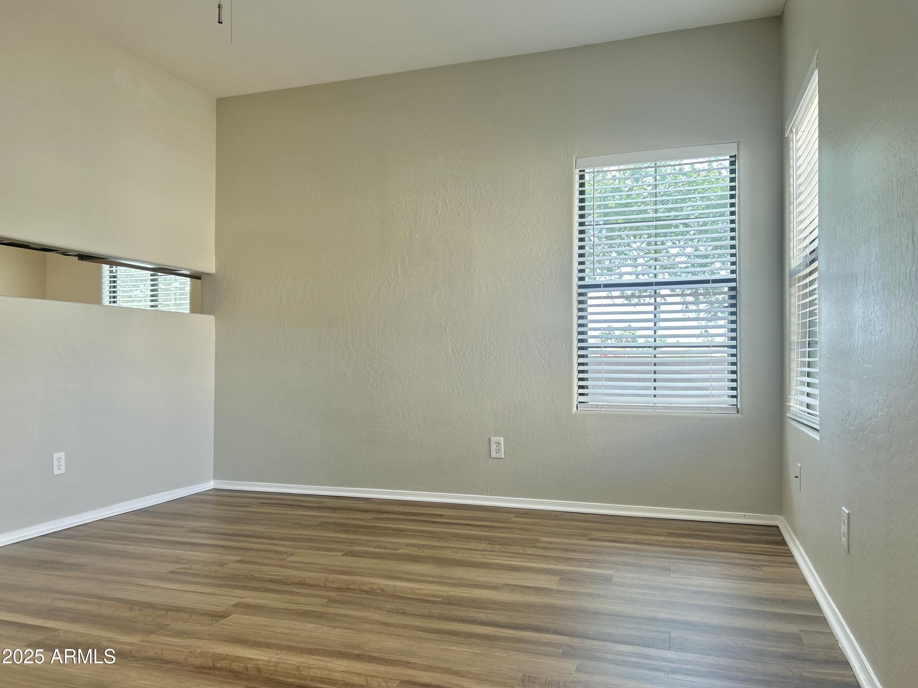 4423 East McLellan Road, Unit 115 Mesa, AZ 85205 - Photo 3 of 16 a view of a room with wooden floor and windows