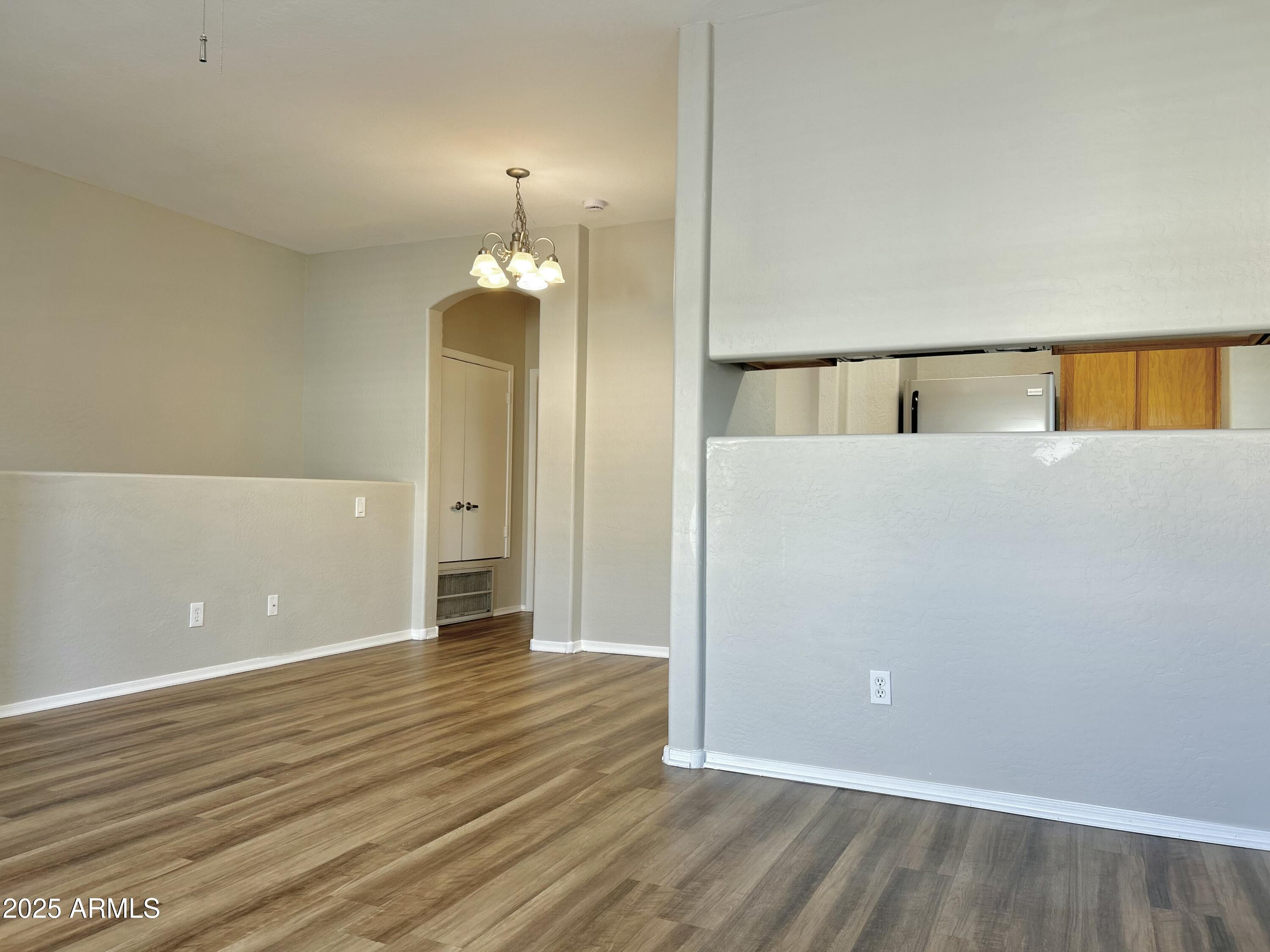 4423 East McLellan Road, Unit 115 Mesa, AZ 85205 - Photo 4 of 16 wooden floor in an empty room with a window