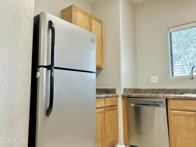a white refrigerator freezer sitting inside of a kitchen