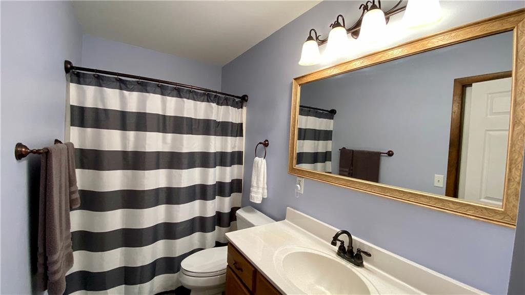 200 Porter Street Springdale, PA 15144 - Photo 15 of 35 a bathroom with a sink a toilet a mirror and shower