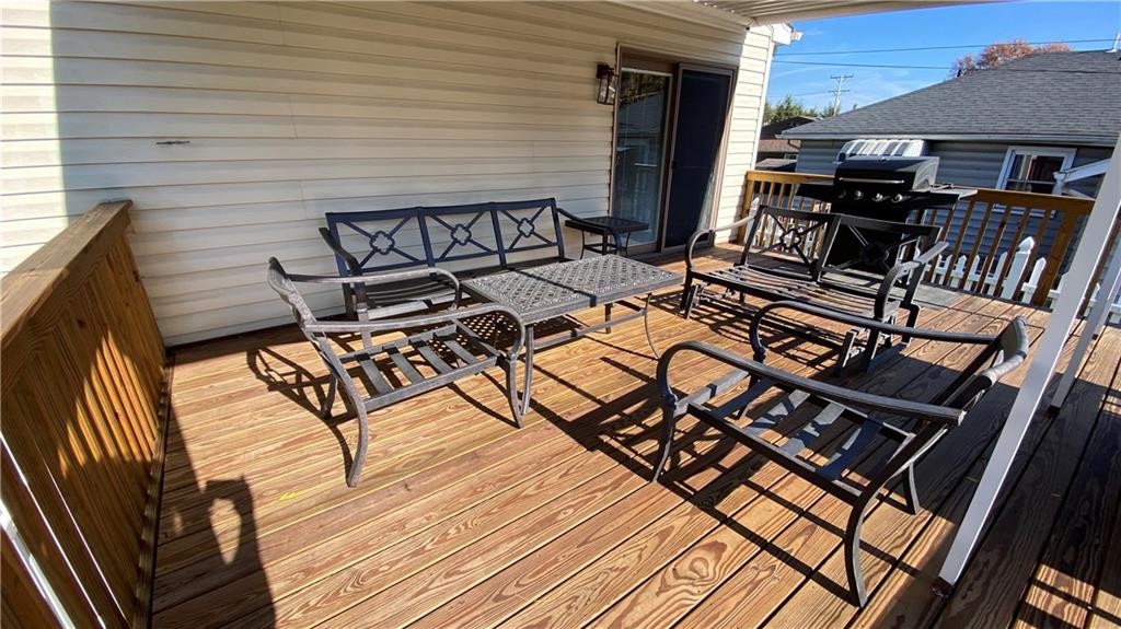 200 Porter Street Springdale, PA 15144 - Photo 28 of 35 a view of a patio with table and chairs with wooden floor and fence