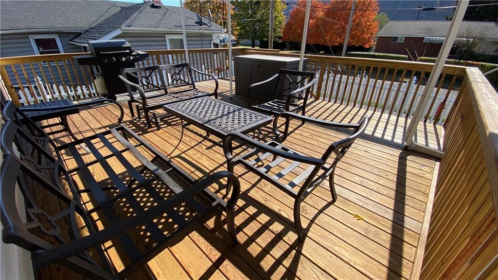 200 Porter Street Springdale, PA 15144 - Photo 29 of 35 a view of a roof deck with table and chairs with wooden floor and fence