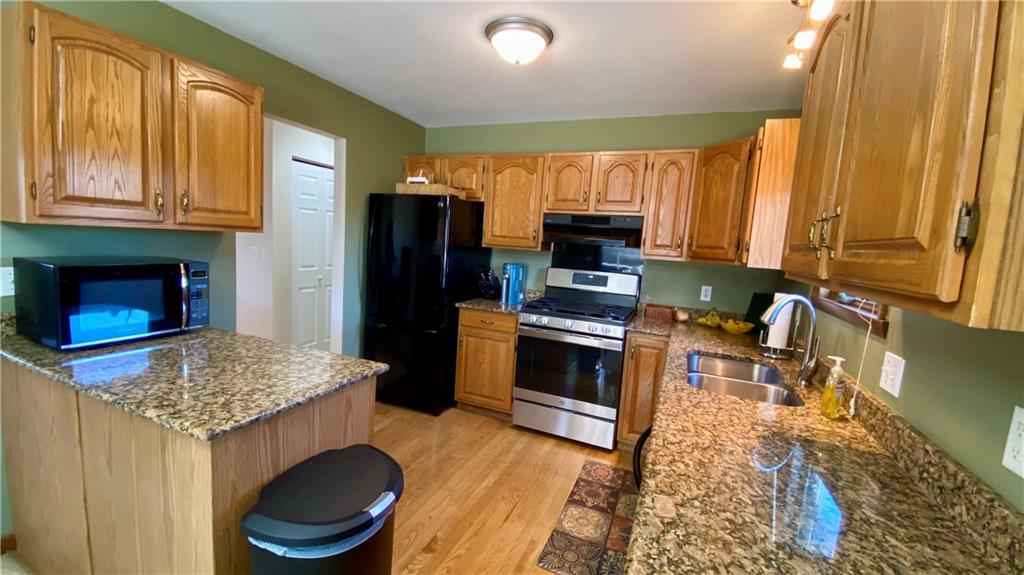 200 Porter Street Springdale, PA 15144 - Photo 7 of 35 a kitchen with stainless steel appliances granite countertop a stove refrigerator and a sink