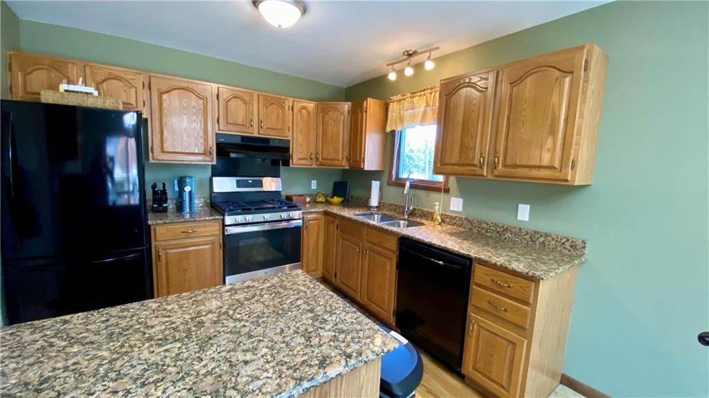 200 Porter Street Springdale, PA 15144 - Photo 8 of 35 a kitchen with stainless steel appliances granite countertop a sink stove refrigerator and a granite counter top
