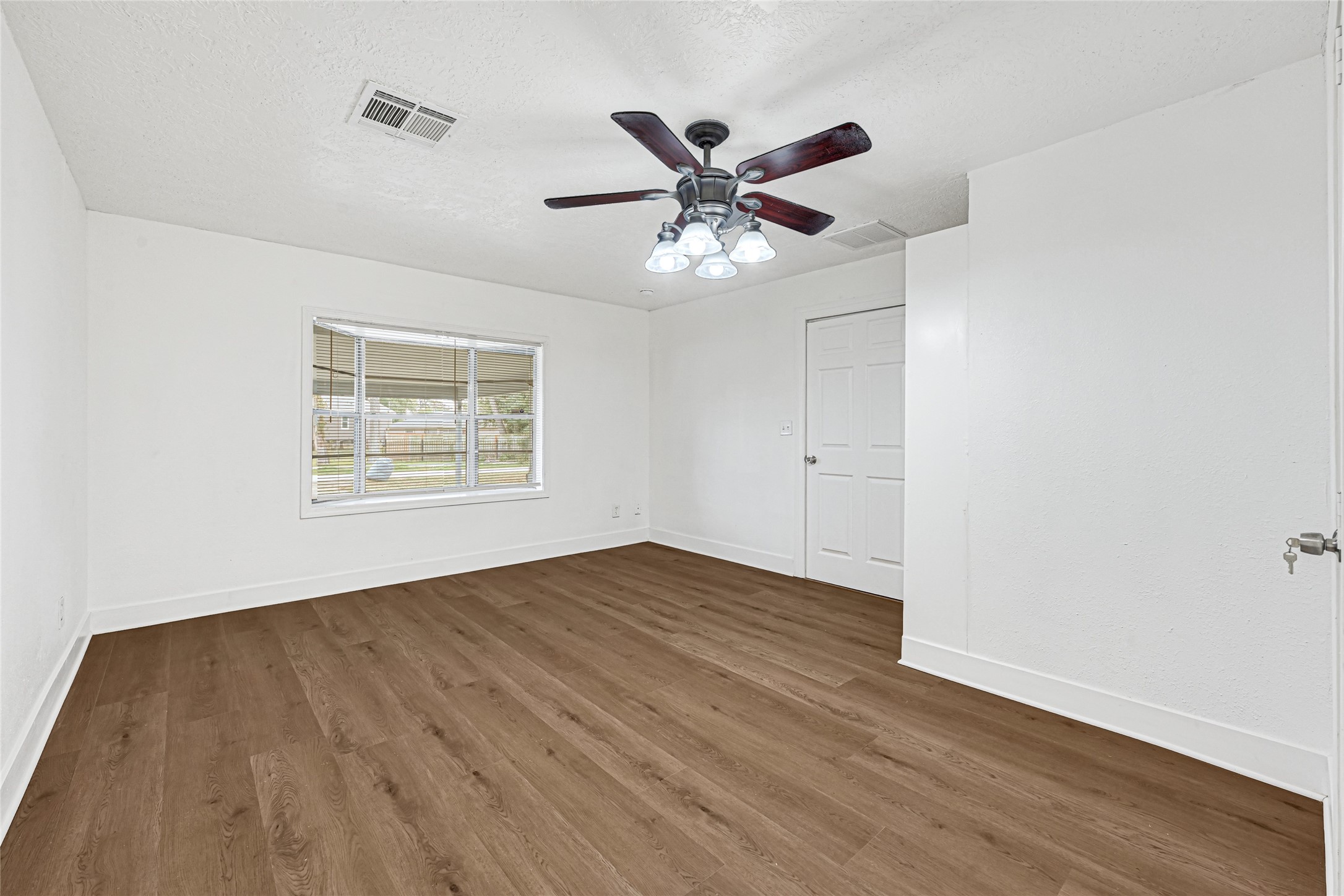 4215 East Lane Houston, TX 77026 - Photo 13 of 25 a view of an empty room with wooden floor and a window